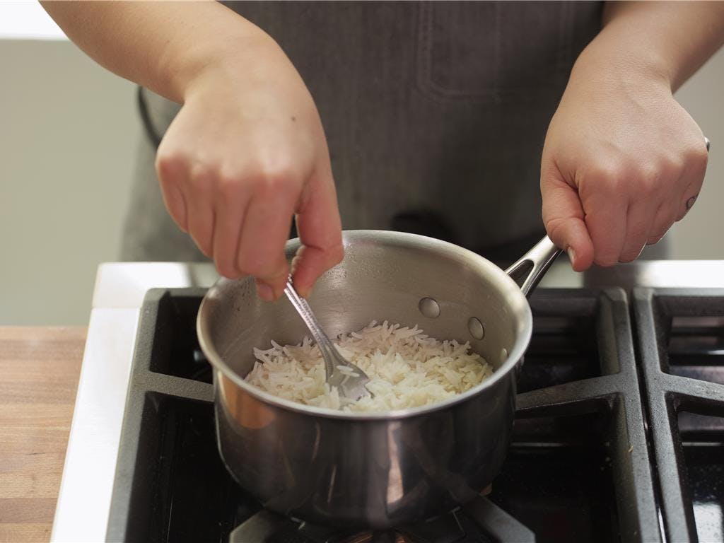  In a medium saucepan, heat the rice over medium heat,