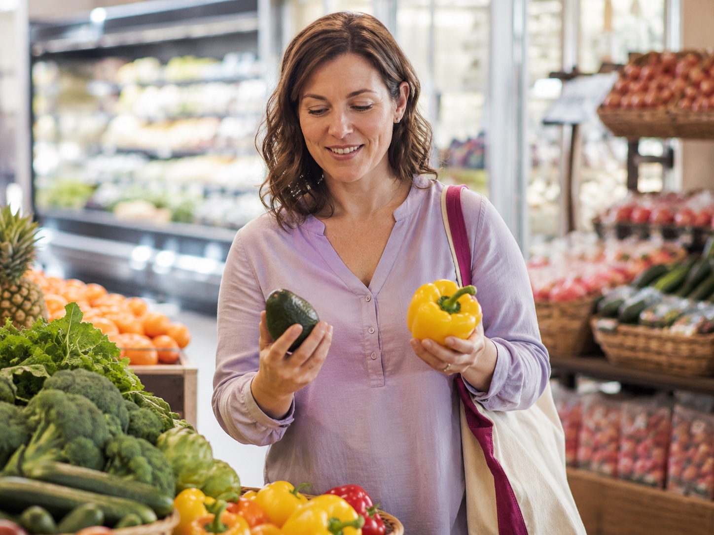Adult comparing fresh produce during a grocery trip.